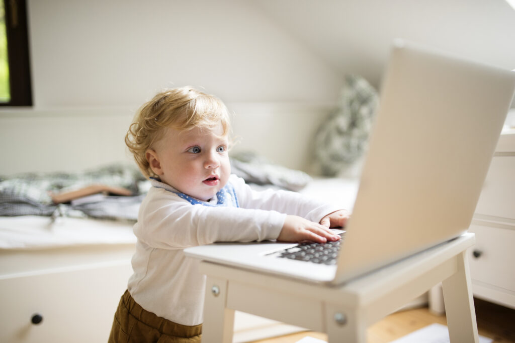 An image of a young boy sitting in front of a laptop with a determined expression on his face. He is finding his future job on jobfindr, a jobs and career platform designed for millennials and Gen Z, with the slogan 'connecting the future.' This image symbolises a young person starting their career journey early and taking proactive steps towards their future success.